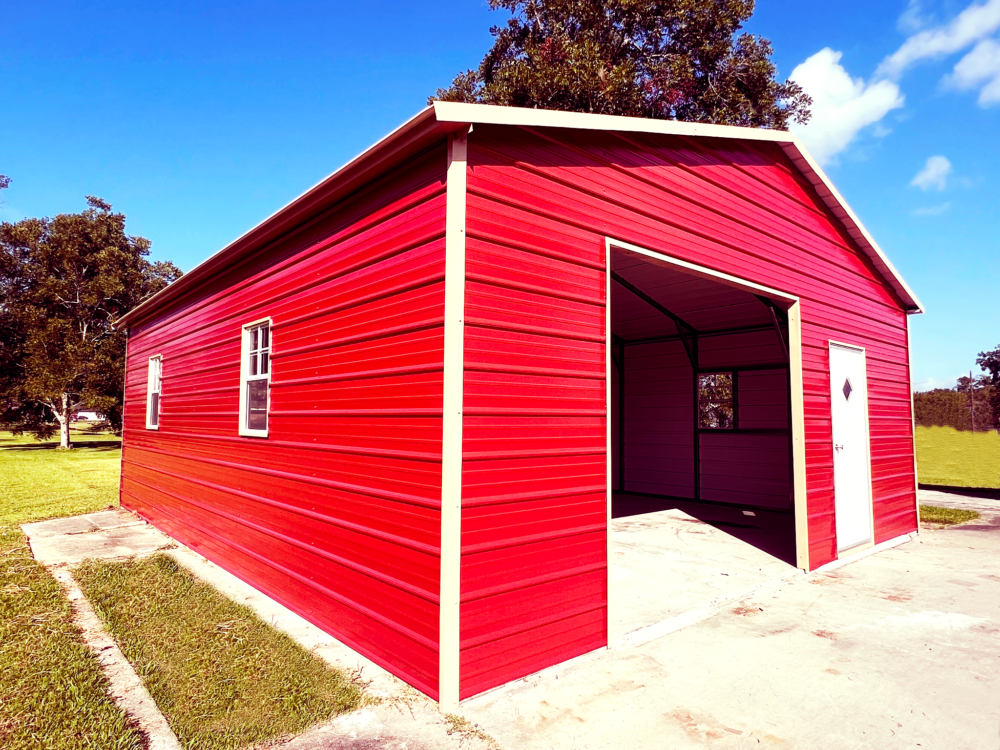 Bright red metal garage with open door on a sunny day.