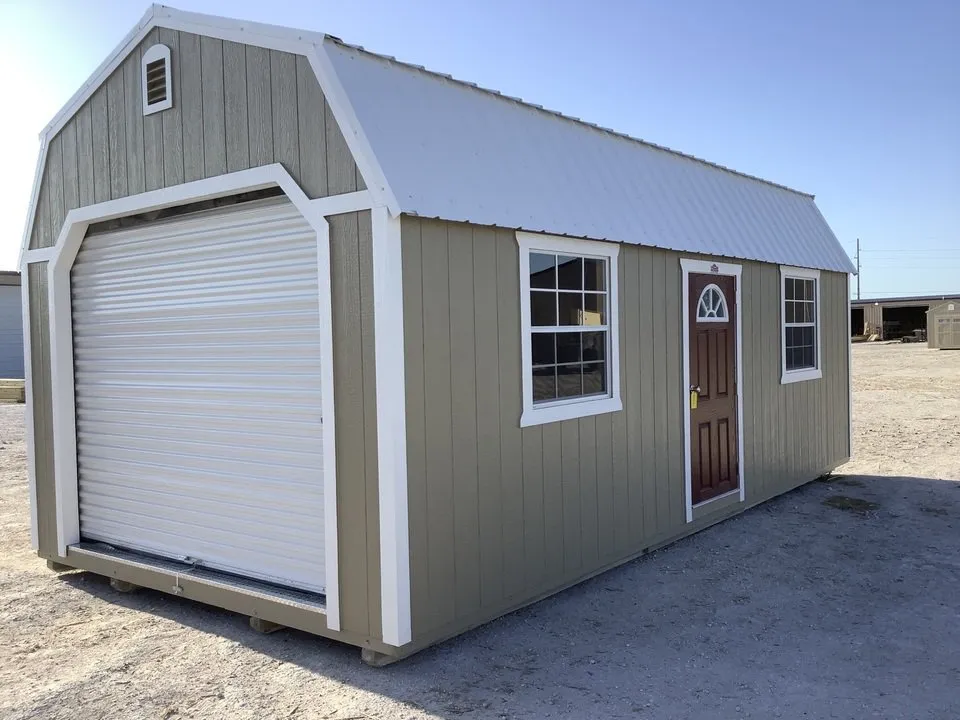 A beige storage shed with white trim and a white garage door.